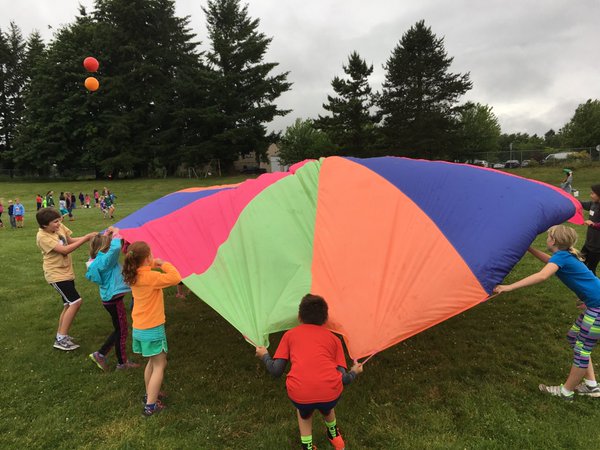 Students playing with parachute