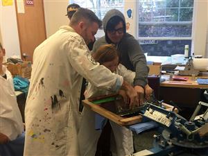 Art Tech teachers and students mentor a Boones Ferry student in the art of print-making. 