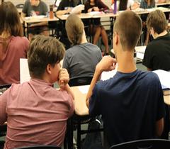 West Linn High School students discuss an assignment.