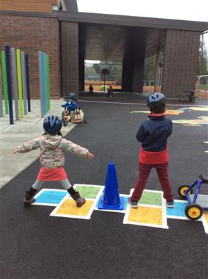 Riding tricycles outside is a popular past time. 