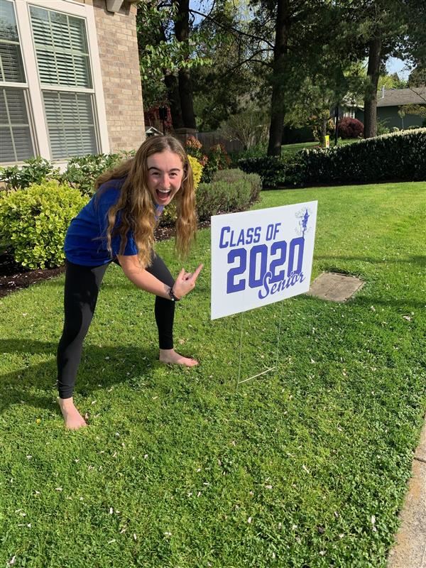 Students celebrate their new yard signs.  