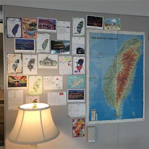 Postcards from Taiwan are posted on a bulletin board 