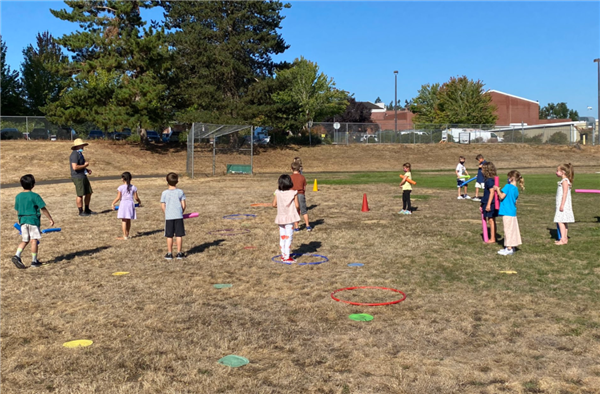 Students participate in an outdoor PE activity. 