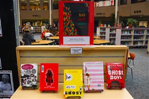 Books celebrating Black History Month are propped up on a table.