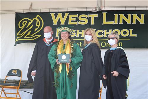 A West Linn High School student celebrates her diploma on Tuesday, June 2. 