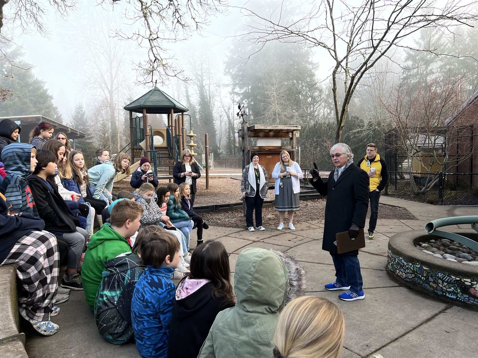 A Rotarian talks about the meaning of a Peace Pole with Bolton students.