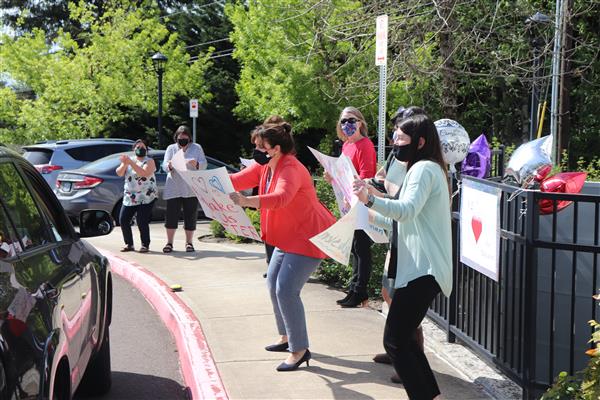 Student Services Staff celebrate teachers with signs.