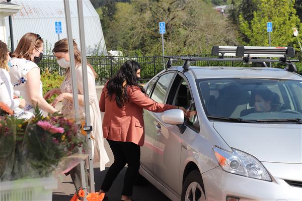 Human Resources staff deliver flowers to employees.