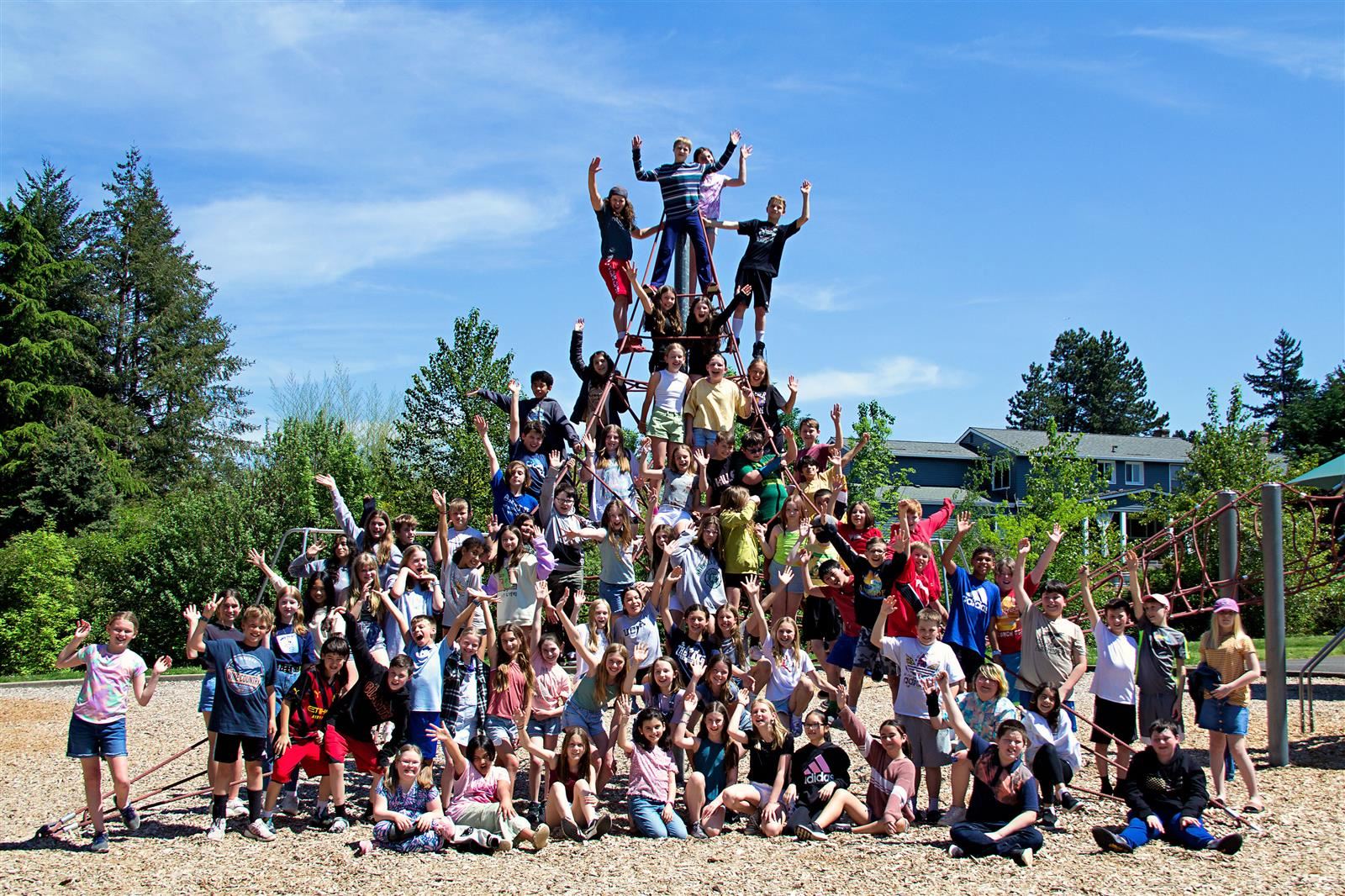 Students take a picture on the play structure.