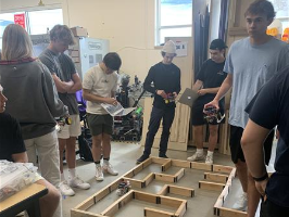 Students programming a robot in a maze