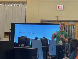 A high school senior leads a computer careers activity